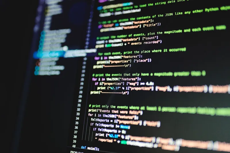 A monitor displaying multiple lines of source code