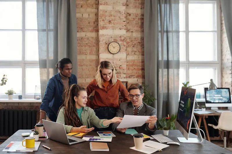 A group of colleagues discussing marketing plans together in an office