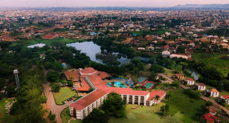 Aerial view of Enugu city, showing a lakeside resort complex and the surrounding urban sprawl