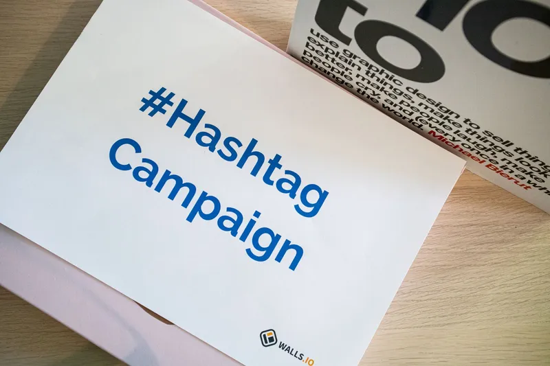 A hashtag campaign graphic displayed on a desk, representing a digital ad campaign