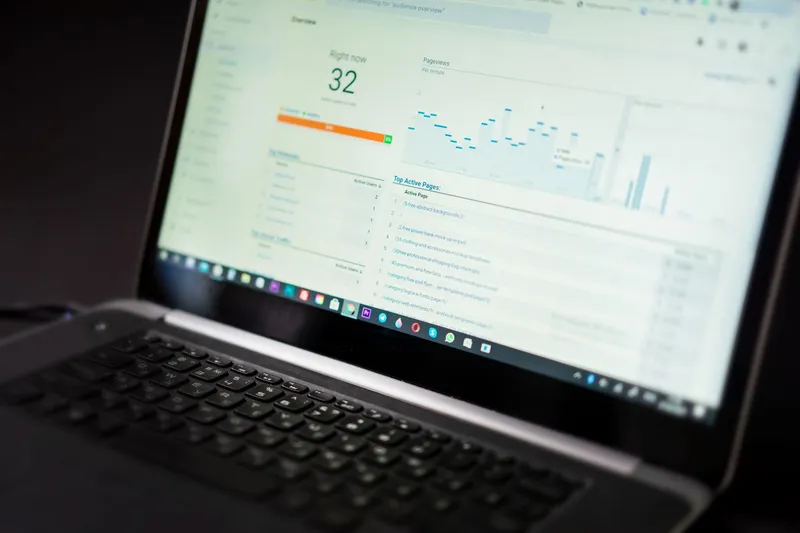 Google Analytics real-time traffic dashboard showing active users and pageviews on a laptop screen